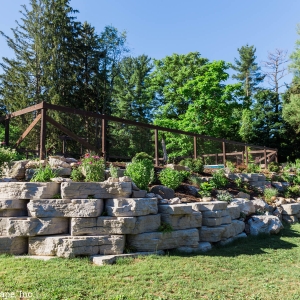 A retaining wall and steps constructed from precast concrete and natural stone in High Falls, NY.