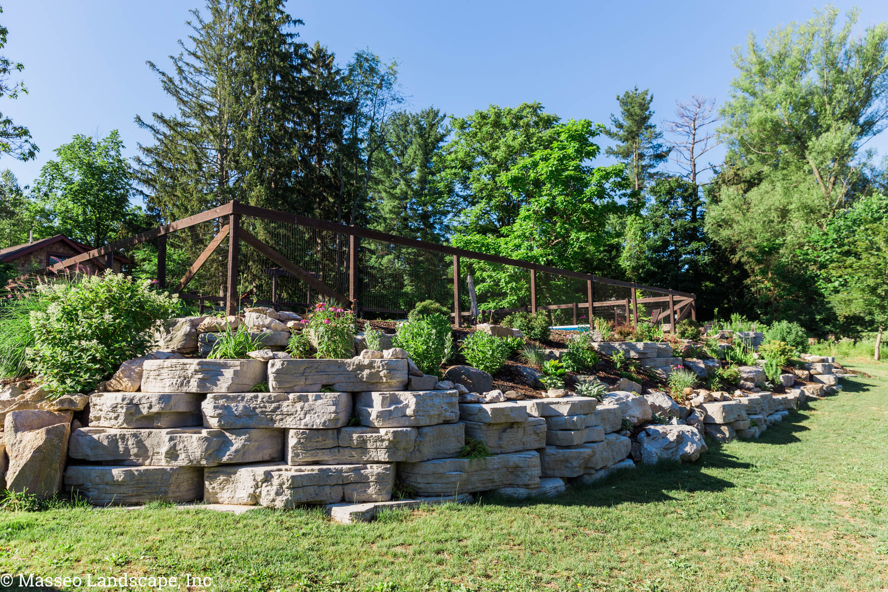 A retaining wall and steps constructed from precast concrete and natural stone in High Falls, NY.