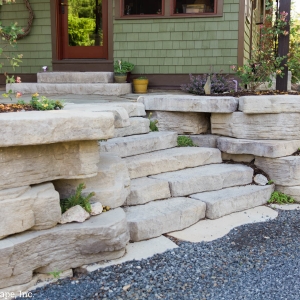 Entryway steps set into a small retaining wall planted with succulents, installed by Masseo Landscape, High Falls Landscape Designers.