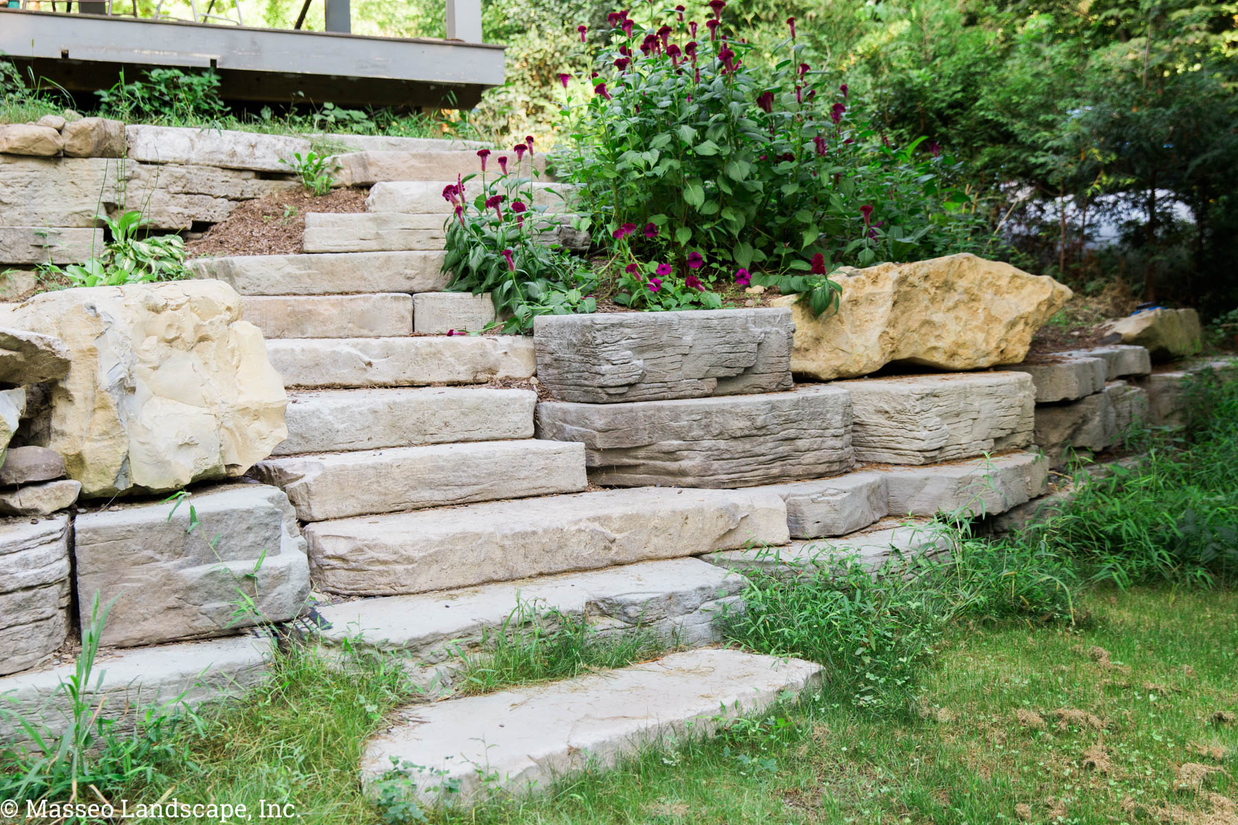 A stone-texture precast concrete entryway and steps installed by Masseo Landscape, High Falls Landscape Designers