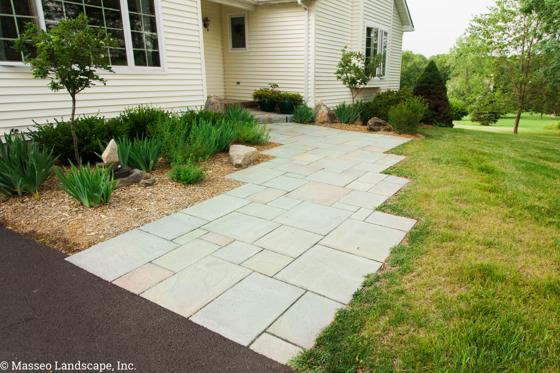 Precast concrete paver walkway and steps with a real brick border.