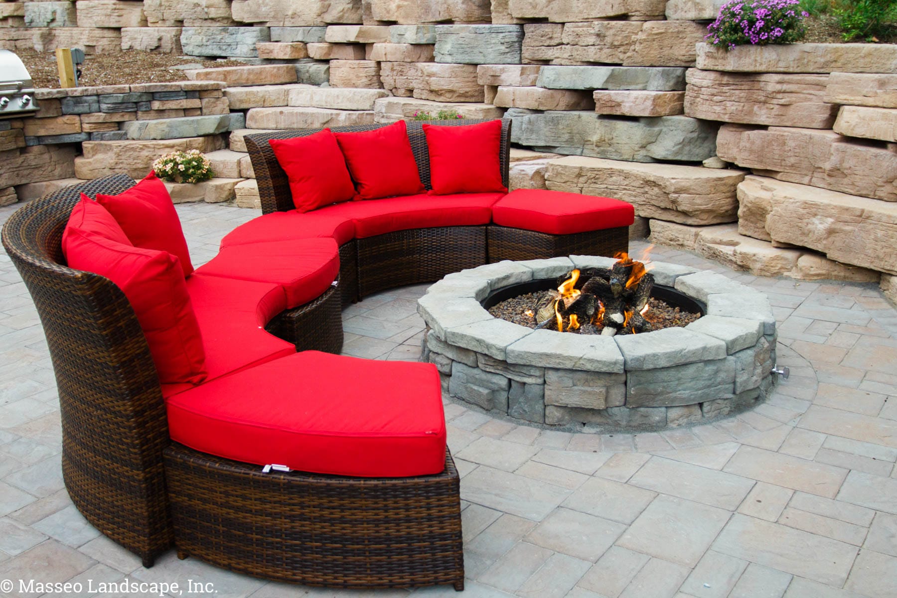 Circular fire pit, geometric patio and a Rosetta Outcropping retaining wall installed by Masseo Landscape, Inc., Highland Landscapers