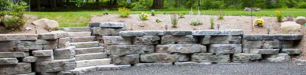 A Rosetta Outcropping wall along a driveway with a built in staircase.