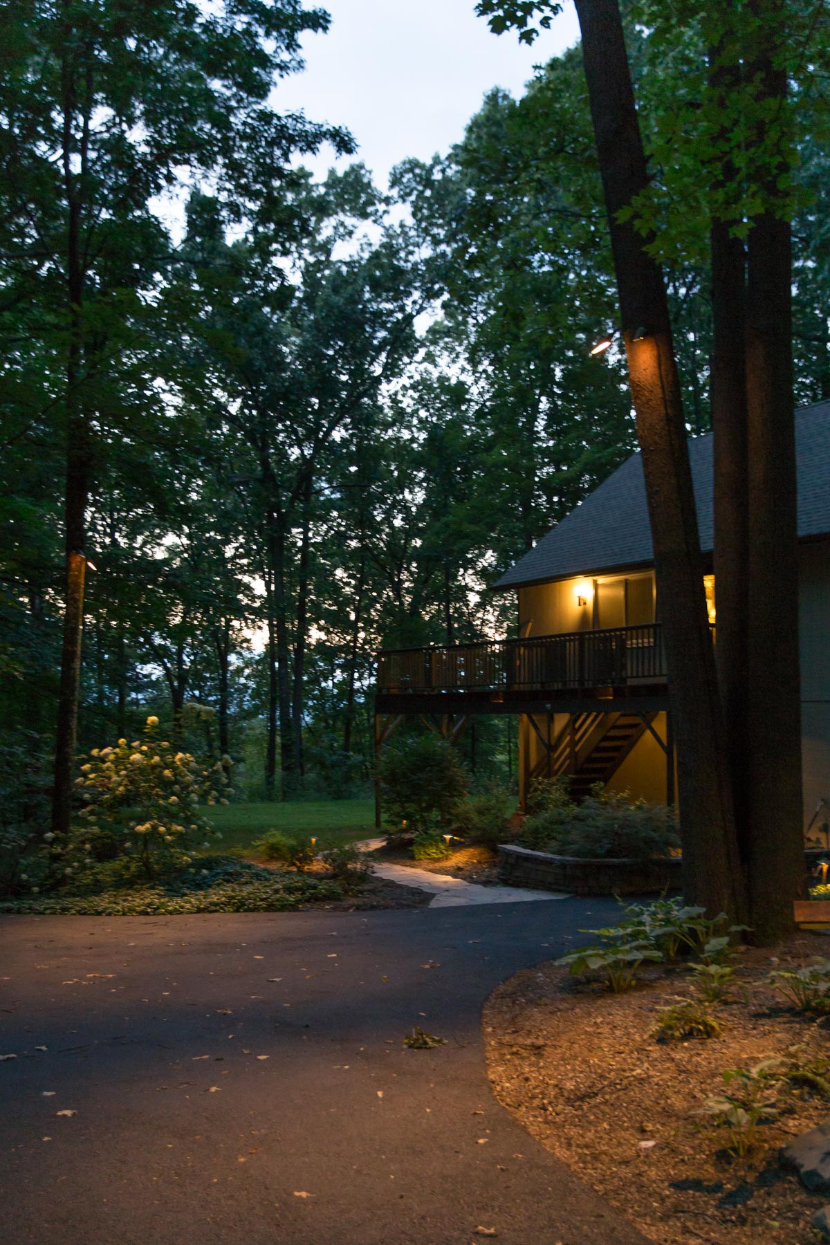 Outdoor lighting scheme around driveway with walkway, retaining walls, down lights and path lighting in New Paltz, NY.