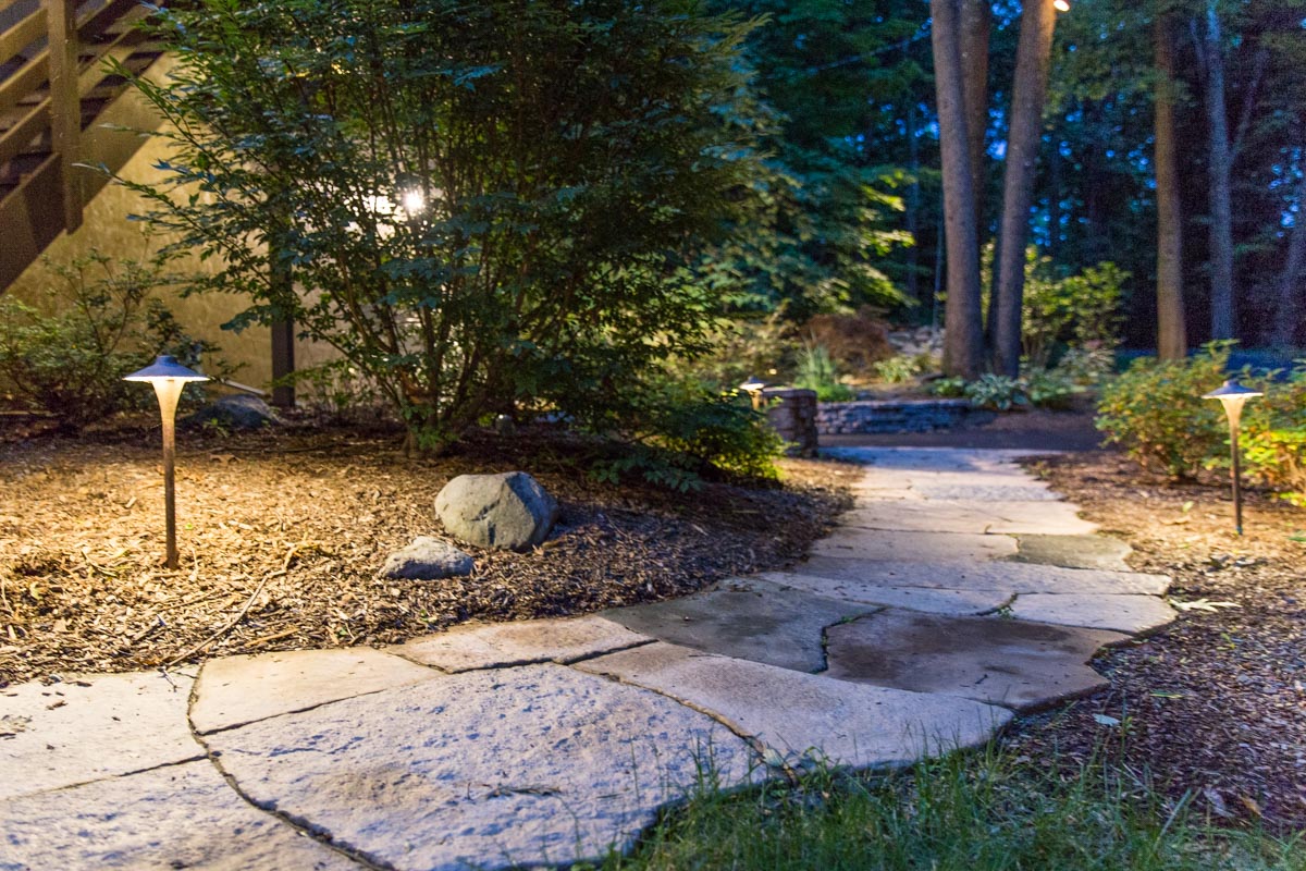 Precast concrete walkway with path lighting installed by Masseo Landscape, Inc.
