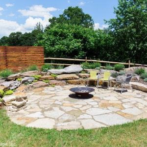 Circular natural stone patio installed by Masseo Landscape, Inc, Gardiner Landscape Contractor