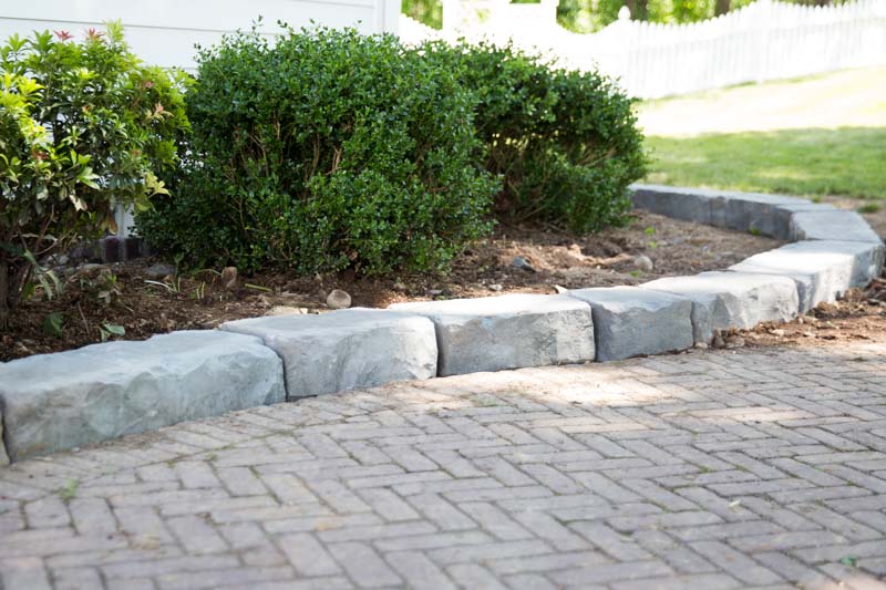 Natural stone textured curbing in a bed space, by Masseo Landscape, New Paltz Landscaping