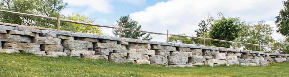 Image of long, low profile stone wall.